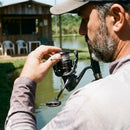 Pescador regulando a fricção do Molinete Shimano Vanford
